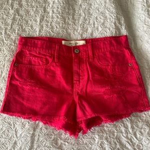Hot pink distressed denim shorts